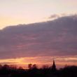 Zonsondergang boven Andel met de Romboutstoren