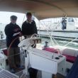 Bakshish. Tom met de loods en de pilotboot op de achtergrond